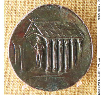 A god standing in a temple on a coin of ancient Korkyra at My Favourite Planet