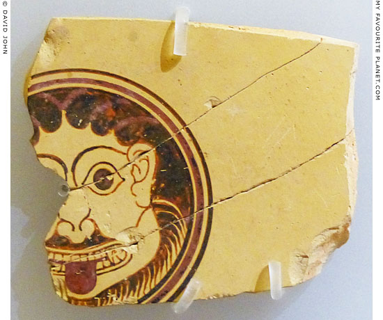 A bearded Gorgon head on a fragment of Corinthian pottery at My Favourite Planet