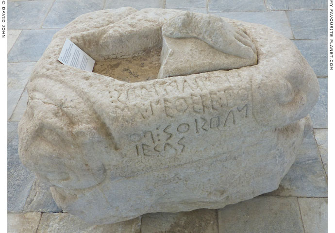 A triangular statue base with the relief of a head at each corner at My Favourite Planet A triangular statue base with the relief of a head at each corner at My Favourite Planet