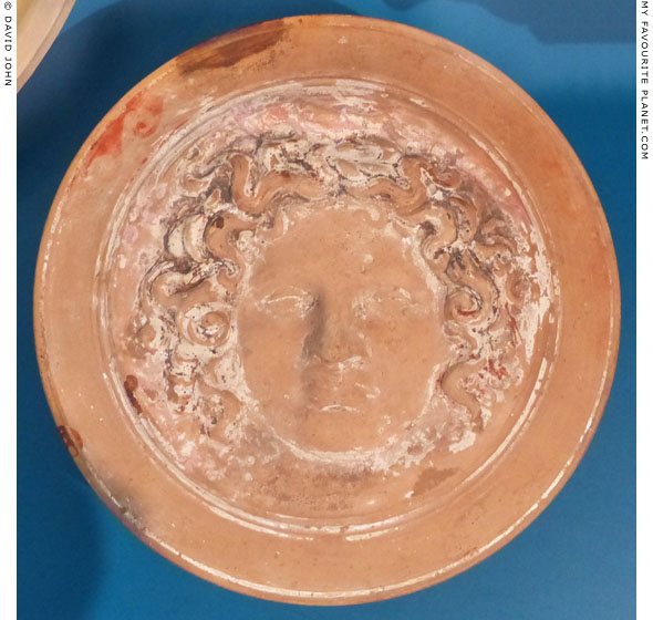 The lid of a terracotta relief pyxis with a Gorgoneion at My Favourite Planet The lid of a terracotta relief pyxis with a Gorgoneion at My Favourite Planet